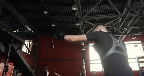 Boxer young man in gloves boxing in gym on personal training, side view. Stock Footage 127101869