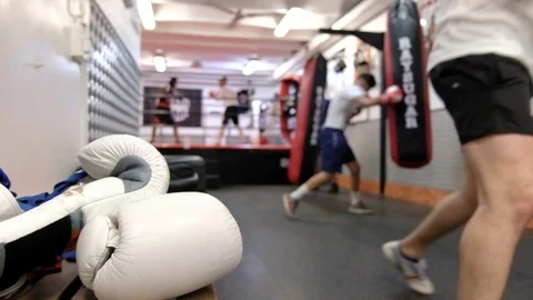 Boxers practicing punch strikes in the training hall Stock Footage 78531757