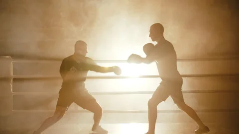 Boxers sparring in smoky ring with backlight Stock Footage 308485232