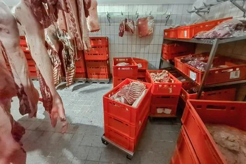 Boxes and containers with packaged meat for storage and transportation. Stock Photos