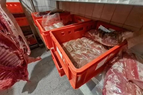 Boxes and containers with packaged meat for storage and transportation. Stock Photos