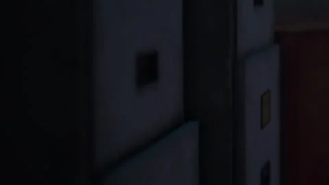 Boxes and containers stored in a dimly lit environment with shadows present Stock-Footage 344970091