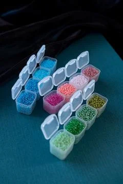 The boxes are filled with colored beads with open Stock Photos
