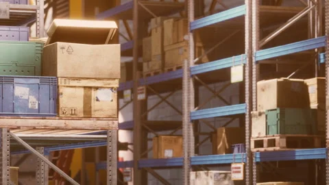 Boxes are stacked on shelves in a warehouse during daylight hours Stock Footage 340016481