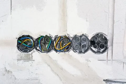 Boxes with cables for electric sockets installed in new house building empty  Stock Photos