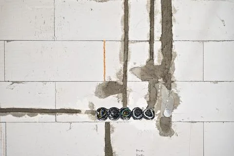 Boxes with cables for electric sockets installed in new house building empt.. Stock Photos