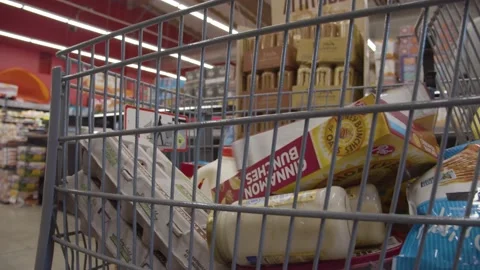 Boxes of cereal being placed in grocery cart Stock Footage 220089254