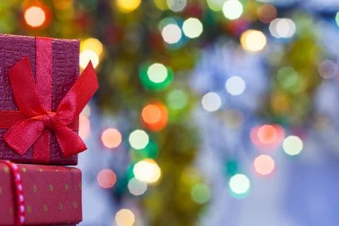 Boxes with christmas gifts with red bow and christmas bokeh light abstract Stock Photos
