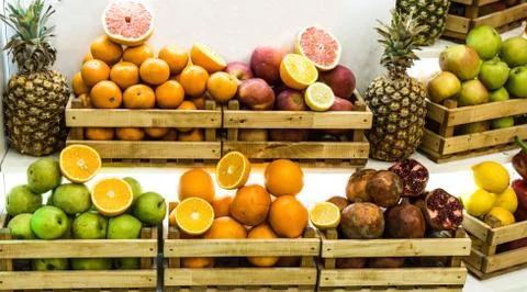 Boxes with different kinds of fresh fruits displayed in wooden crates at the Stock Photos