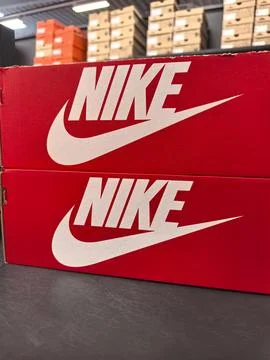 Boxes displaying iconic logo at a retail store during busy shopping hours Stock Photos