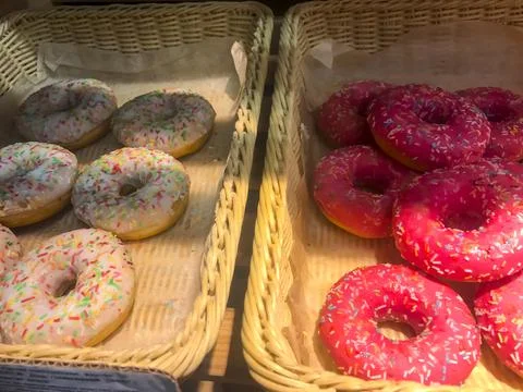 Boxes with donuts on shelves of bread shop, Hanukkah celebration Stock Photos