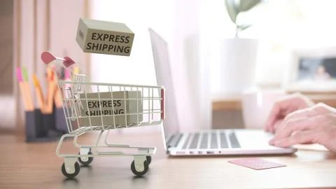 Boxes with EXPRESS SHIPPING text fall in shopping cart after ordering by Stock Illustration