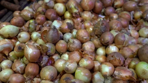 Boxes filled with fresh onion bulbs displayed on a store counter Stock Footage 323145167