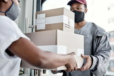 Boxes, front door and delivery man with woman, mask and distribution for pa.. Stock Photos