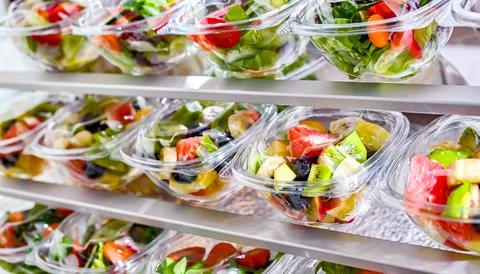 Boxes with fruit and vegetable salads in a commercial fridge Stock Photos