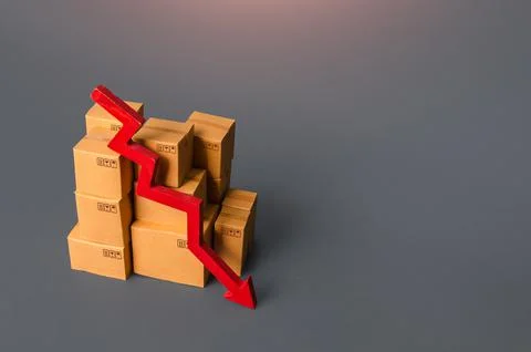 Boxes with goods and a red down arrow. Revenue drop in trade and transportati Stock Photos