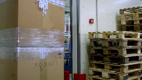 Boxes with goods carried by worker on cart in storehouse Stock Footage 240213210