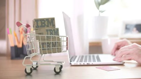 Boxes with IBM logo in shopping trolley near customer with laptop. Editorial Stock Illustration