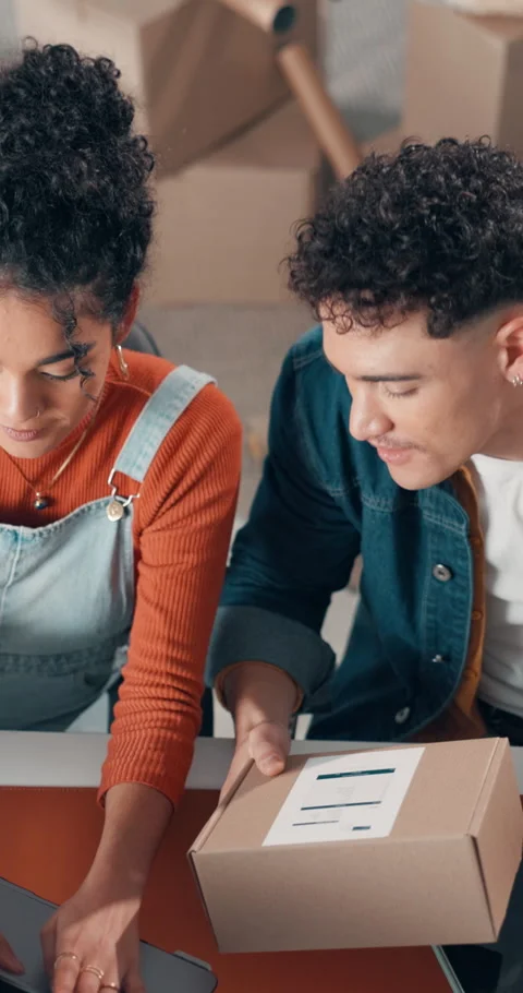 Boxes, laptop and typing with people in office together for delivery or parcel Stock Footage 319818317