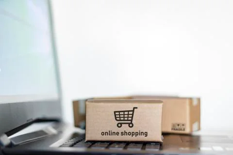 Boxes on laptop. Online shopping, e-commerce concept Stock Photos