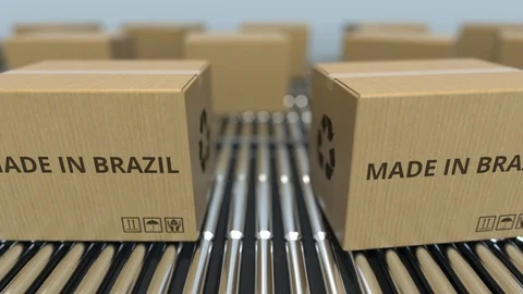Boxes with MADE IN BRAZIL text on roller conveyor. Brazilian goods related Video stock 108968546