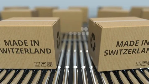 Boxes with MADE IN SWITZERLAND text on roller conveyor. Swiss goods related Video stock 108986620
