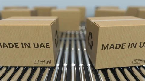 Boxes with MADE IN UAE text on roller conveyor. United Arab Emirates goods Video stock 109044885