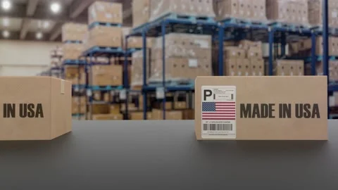 Boxes with MADE IN USA text on roller conveyor. American goods related loopable Video stock 178516295