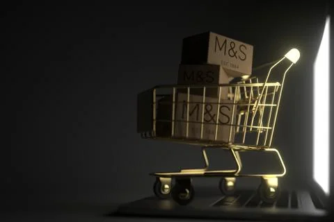 Boxes with MARKS AND SPENSER logo in golden shopping cart on computer keyboard Stock Illustration