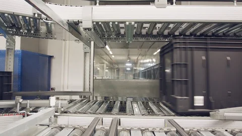 Boxes moving on conveyors in a large automated warehouse Stock Footage 100469177