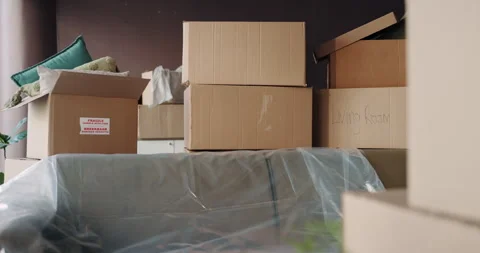 Boxes, moving in or relocation with empty room in new house for property Stock Footage 316296521