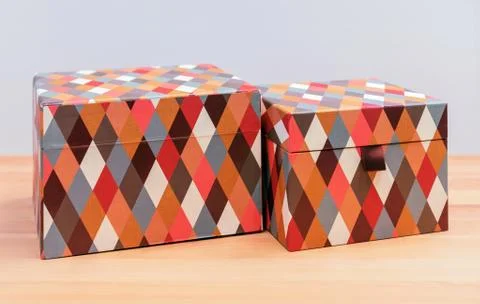 Boxes with multi-colored diamond-shaped pattern for gift wrapping. Stock Photos