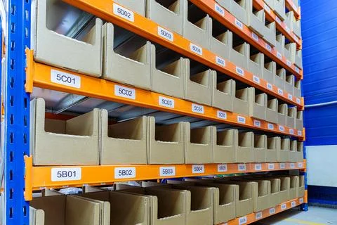 Boxes on racks in a warehouse of goods close-up. Stock Photos