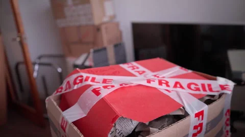 Boxes stacked for house move - gentle slow motion move Stock Footage 275174037
