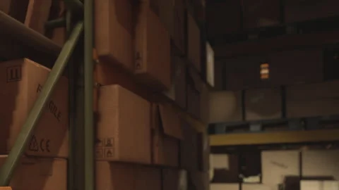 Boxes stacked in a warehouse during daytime Stock Footage 343495918