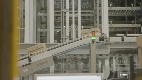 Boxes Transported on Conveyor Belt in Automated Industrial Warehouse Facility Stock Footage 334053258