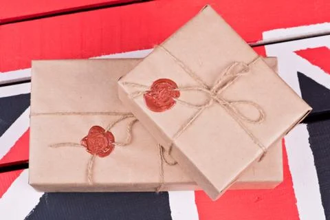 Boxes, wrapped into craft paper, fixed with packthread with a wafer Stock Photos