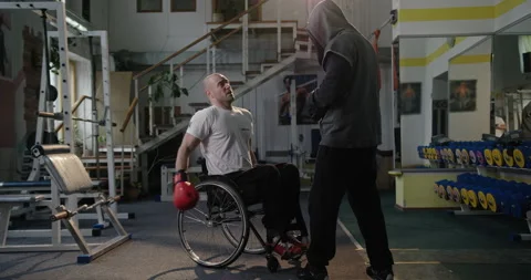 Boxing with a coach in boxing gloves is exhausting Training in the gym Stock Footage 154250238