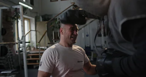 Boxing with a coach in boxing gloves Training in the gym man smiling Paralympian Stock Footage 154255542