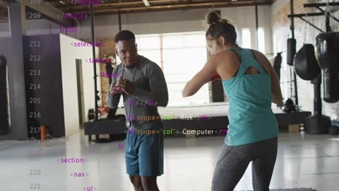 Boxing coach cueing trainee throwing jabs then cross for timing, red wraps, code Stockbeeldmateriaal 329472995