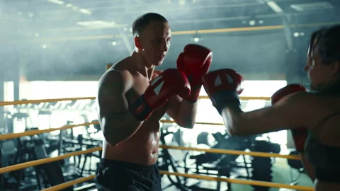 Boxing Coach Expertly Training Determined Female Boxer in Technical Skills Stock Footage 270706006