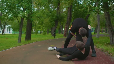 Boxing drill amid trees, Combat training outdoors on cloudy day with Stock Footage 333647269