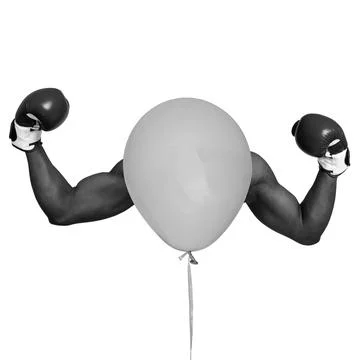 Boxing gloves and a balloon create a fun and playful visual on a white back.. Stock Photos
