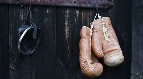 Boxing gloves and diving mask hanging on old wooden door. Video stock 68954431