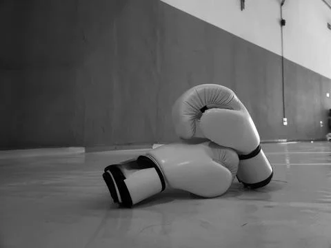 Boxing gloves on training floor Stock Photos