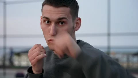 Boxing in Paradise: Guy Shadowboxes on Palm-Encircled Basketball Court Stock Footage 243169383