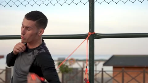 Boxing in Paradise: Guy's Training Session on a Palm-Encircled Basketball Court Stock Footage 243169698