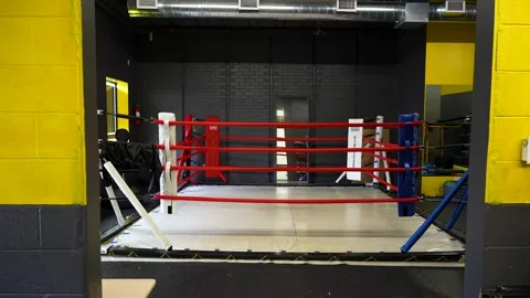 Boxing Ring View Framed by Punching Bag in Training Gym Stock Footage 330576559
