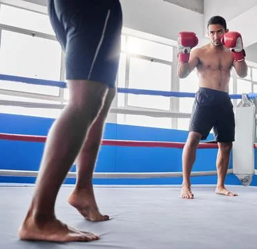Boxing, sports and fight with a man athlete in the ring with a rival for Stock Photos