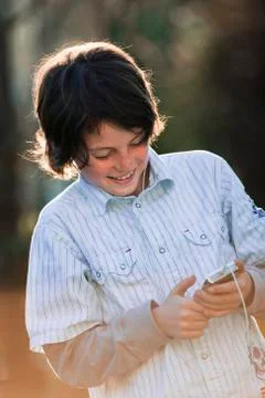 Boy (10-11) using mp3-player Stock Photos